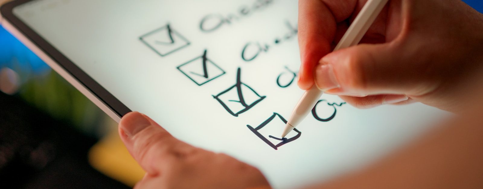 A hand marks off items on a checklist.